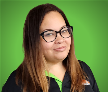 female in front of green background