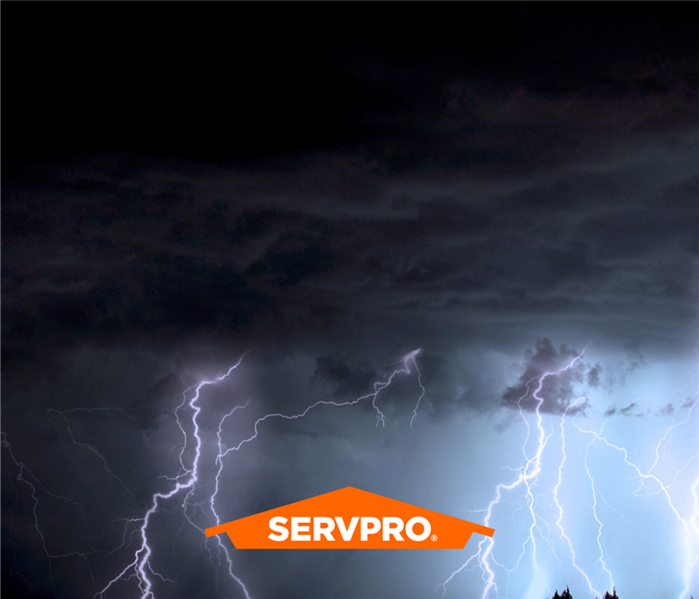 A SERVPRO logo over a clouds and lightning.